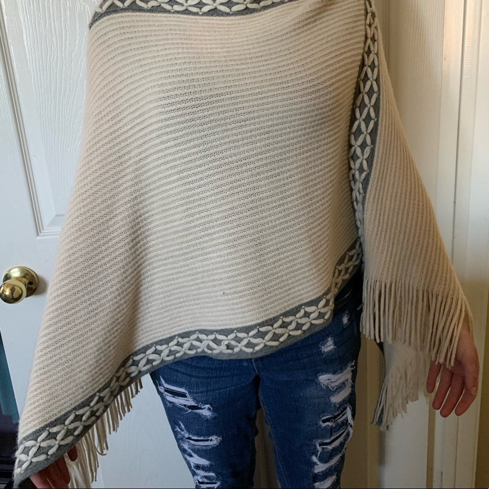 Knit cream and grey asymmetric poncho with fringe
